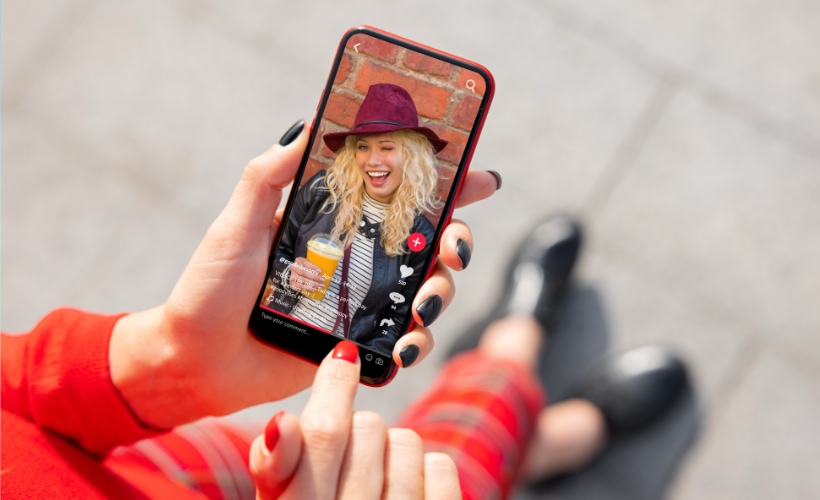 Tiktok Ads playing on a phone optimized by WebCie Agency.